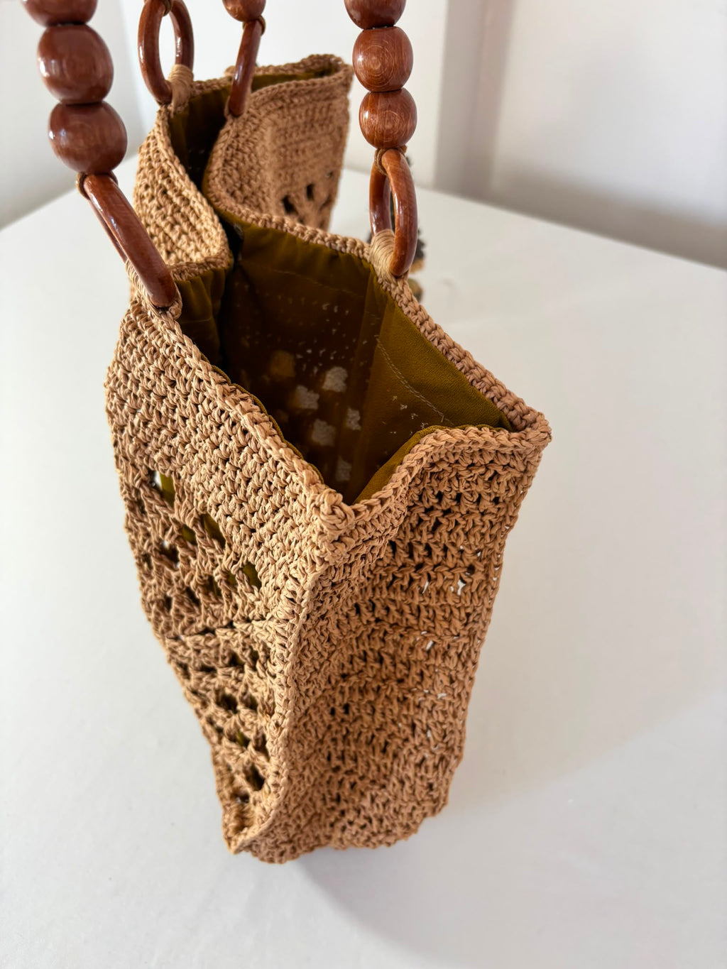 Artisan woven raffia handbag showcasing detailed crochet craftsmanship, making every piece truly one of a kind.