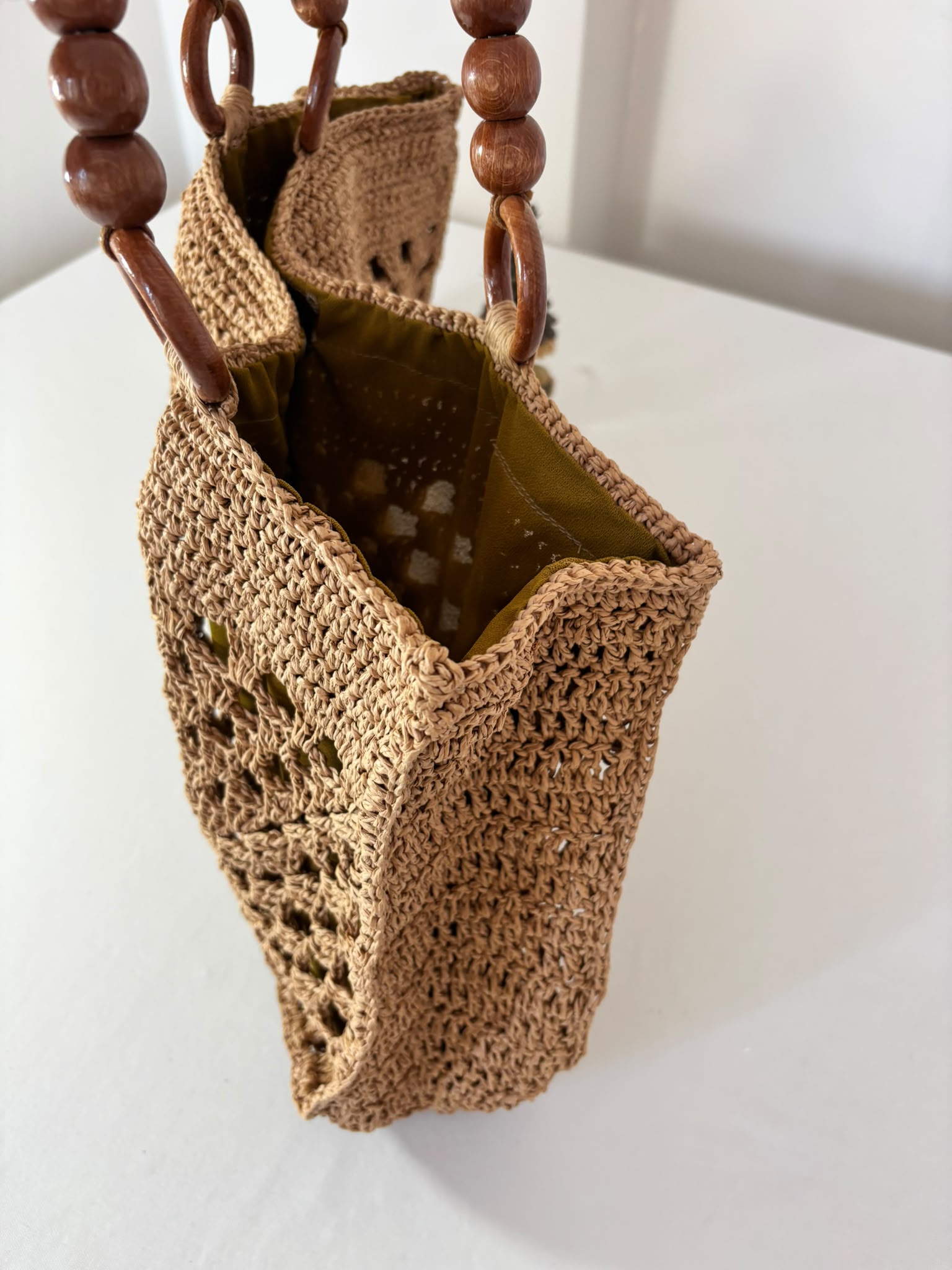 Artisan woven raffia handbag showcasing detailed crochet craftsmanship, making every piece truly one of a kind.