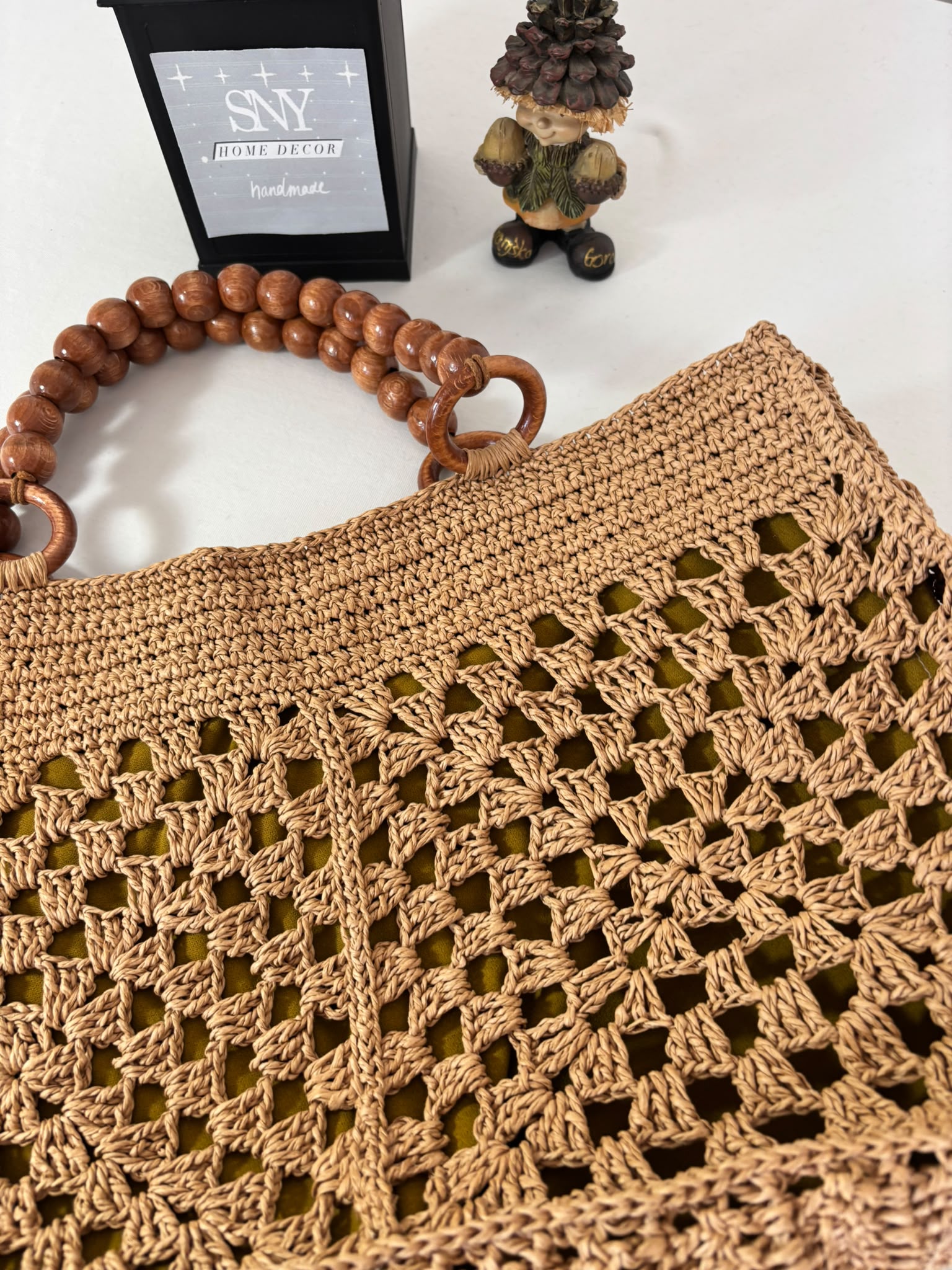 Premium handmade raffia market bag with breathable open crochet design and elegant natural texture.