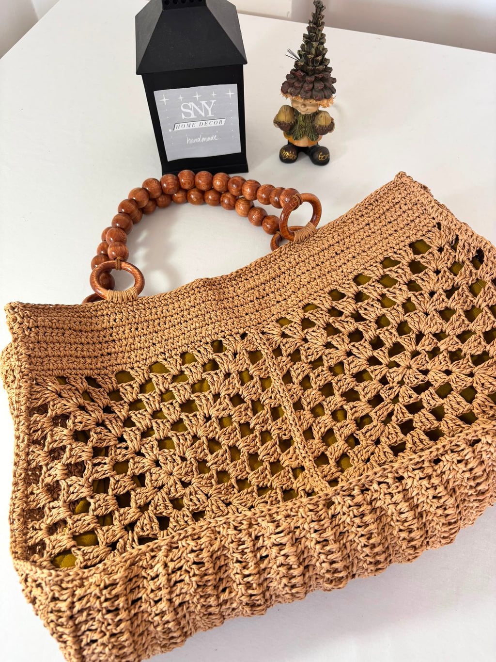 Handmade raffia crochet tote bag with wooden bead handles, perfect for beach days, shopping, and everyday summer style.