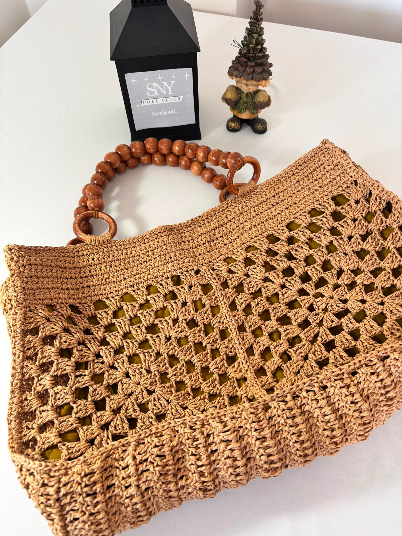 Handmade raffia crochet tote bag with wooden bead handles, perfect for beach days, shopping, and everyday summer style.